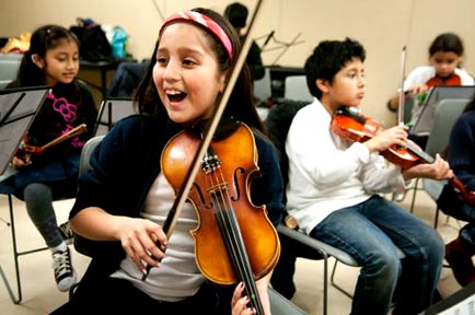 Latino children learning to play music in Corona Youth Music Project. 