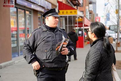 NYPD Vision Zero Street Team Member Speaks with a Pedestrian