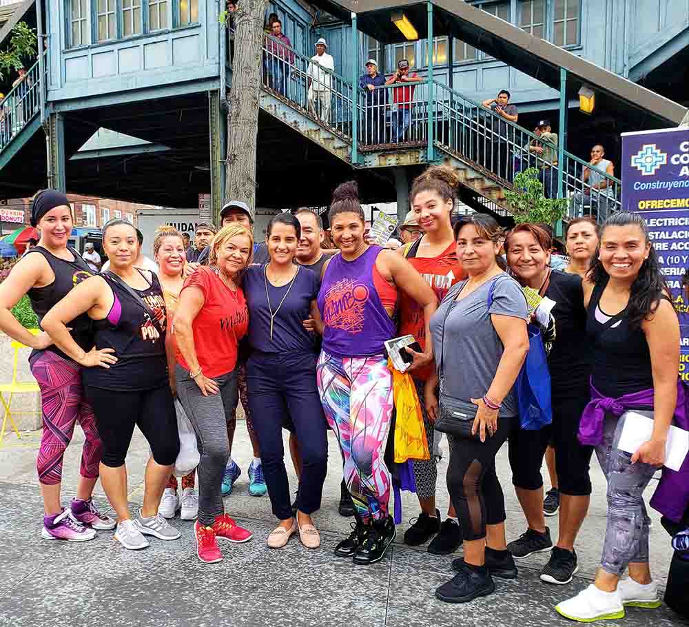 Assemblywoman Ari Espinal, at center in blue, with women after exercising. 